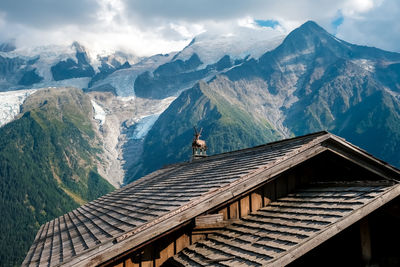 House on mountain against sky