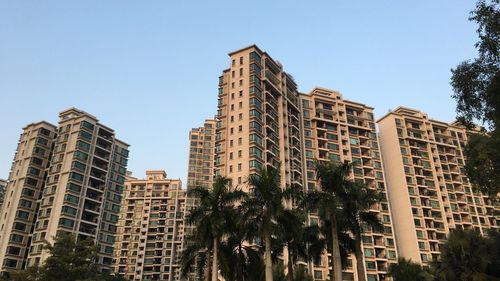 Low angle view of skyscrapers against clear sky