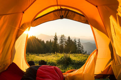 Close-up of tent on grass field against sky