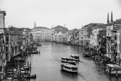 Boats in river with buildings in background