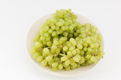 Directly above shot of fruits in bowl against white background