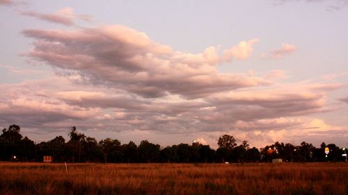 Scenic view of field against sky during sunset