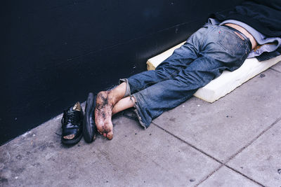 High angle view of homeless man sleeping on footpath