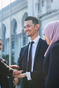 Man and woman standing in front of office building