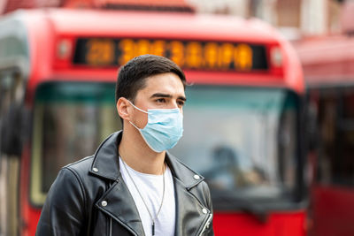 Portrait of young man wearing protective mask