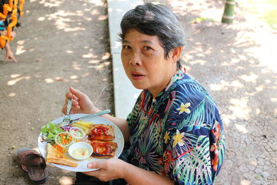 Portrait of woman eating food