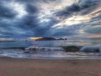 Scenic view of beach against sky during sunset