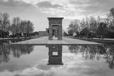 Reflection of trees in lake against sky. debod temple in madrid.