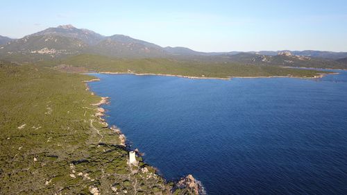 High angle view of sea and mountains against sky