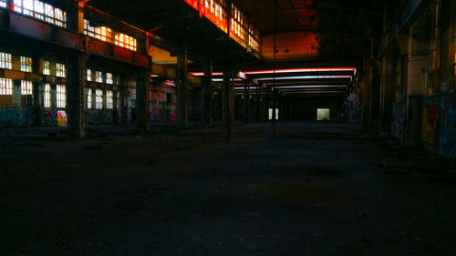 Empty illuminated abandoned building at night