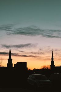 Silhouette of building against sky during sunset