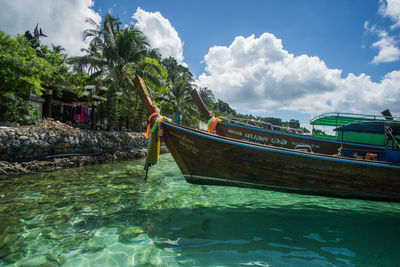 Boat moored on sea against sky