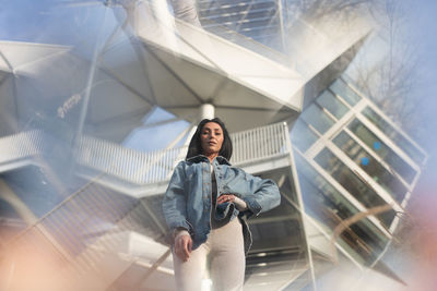 Portrait of young woman in city