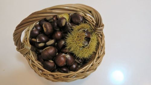 High angle view of chestnuts in wicker basket on table