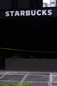 Information sign on railing in city at night