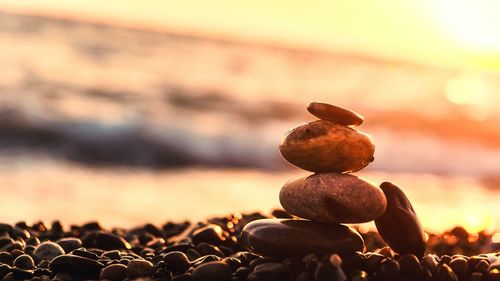 Stack of rock at beach during sunset