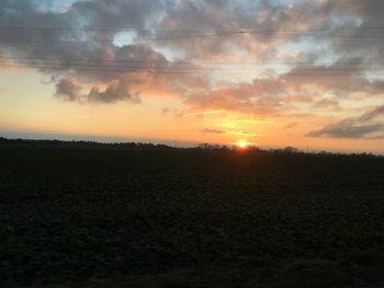 Scenic view of field against sky during sunset