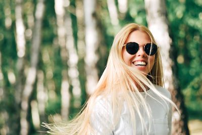 Portrait of smiling woman in forest