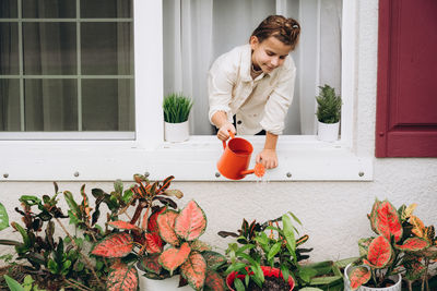 Girl watering plants from a watering can