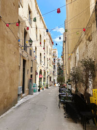 People walking on street amidst buildings in city