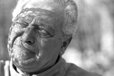 Man looking away with shadow and sunlight on face