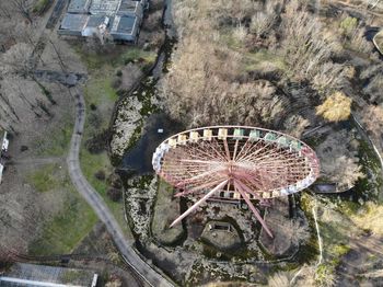 High angle view of ferris wheel by building in city