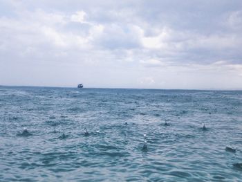 Scenic view of sea against cloudy sky