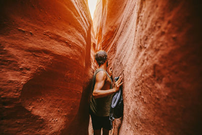 Rear view of person standing on rock