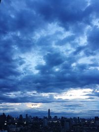 City skyline against cloudy sky