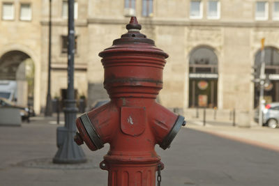 Close-up of fire hydrant against buildings in city