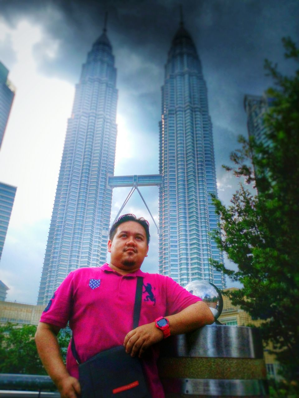 architecture, built structure, building exterior, tall - high, tower, lifestyles, city, leisure activity, skyscraper, person, casual clothing, modern, famous place, capital cities, sky, travel destinations, standing, tourism