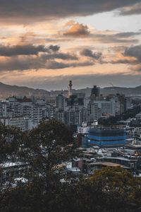 High angle view of buildings in city against sky during sunset