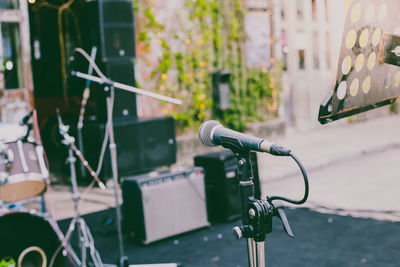 Close-up of microphone with speakers in background