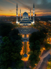 Low angle view of mosque against sky during sunset