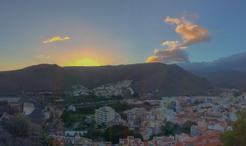 High angle shot of townscape against sky at sunset