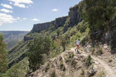 One man running on a trail at a canyon in barranca de meztitlan