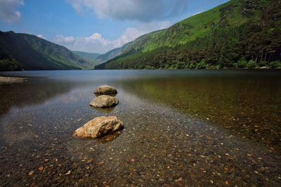 Scenic view of lake against cloudy sky