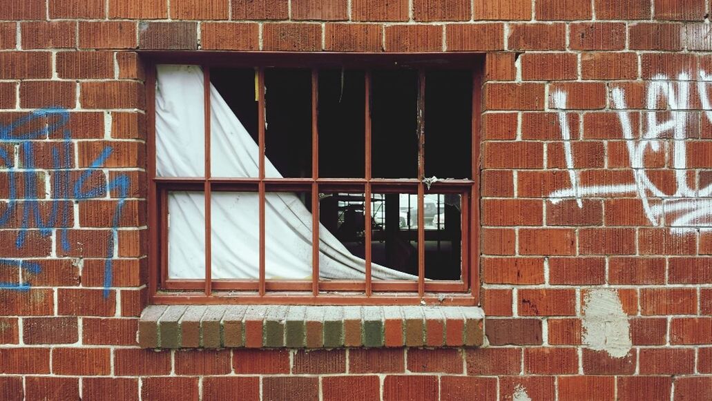 building exterior, architecture, built structure, window, brick wall, reflection, glass - material, wall - building feature, pattern, building, outdoors, wall, day, no people, red, city, close-up, glass, transparent, low angle view