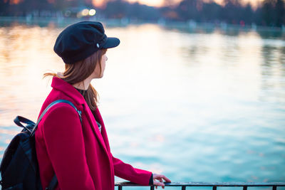 Woman wearing hat against lake