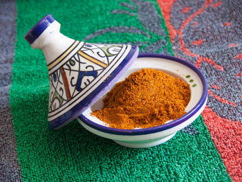 High angle view of fresh ingredient in ceramic container on napkin