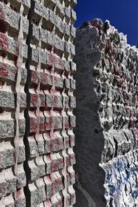 Low angle view of stone wall against sky