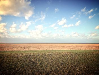 Scenic view of landscape against cloudy sky