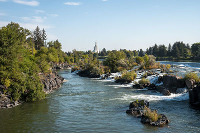 Snake river leading towards temple in idaho falls during summer