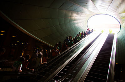 Low angle view of tourists on escalators at universal studio singapore