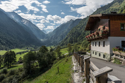 Scenic view of houses and mountains against sky