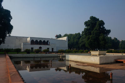 View of swimming pool by building against sky