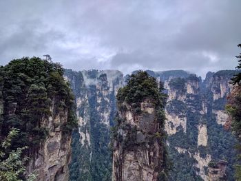 Panoramic view of trees and rocks against sky