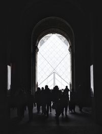 Silhouette people walking indoors