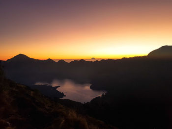 Scenic view of silhouette mountains against sky during sunset