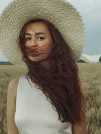 Portrait of beautiful young woman in hat